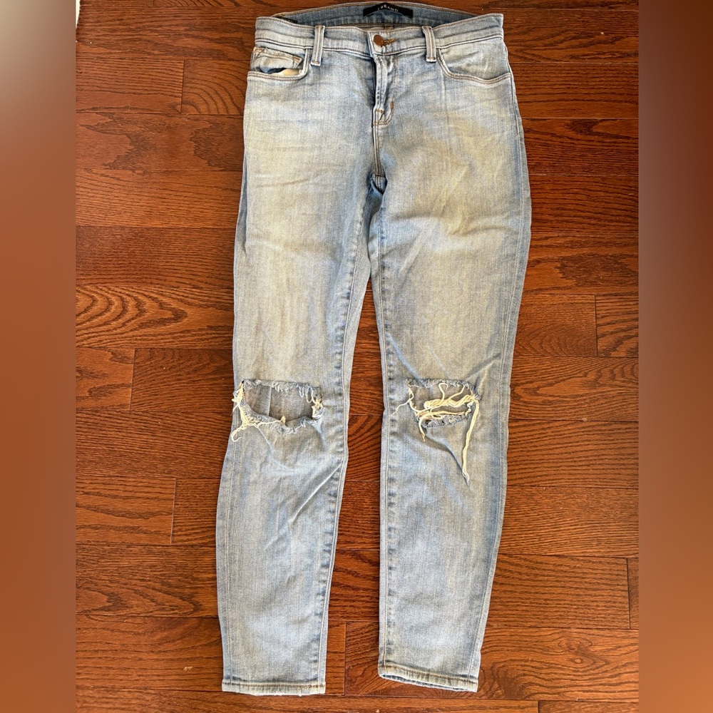 J Brand light blue jeans with rips at the knees